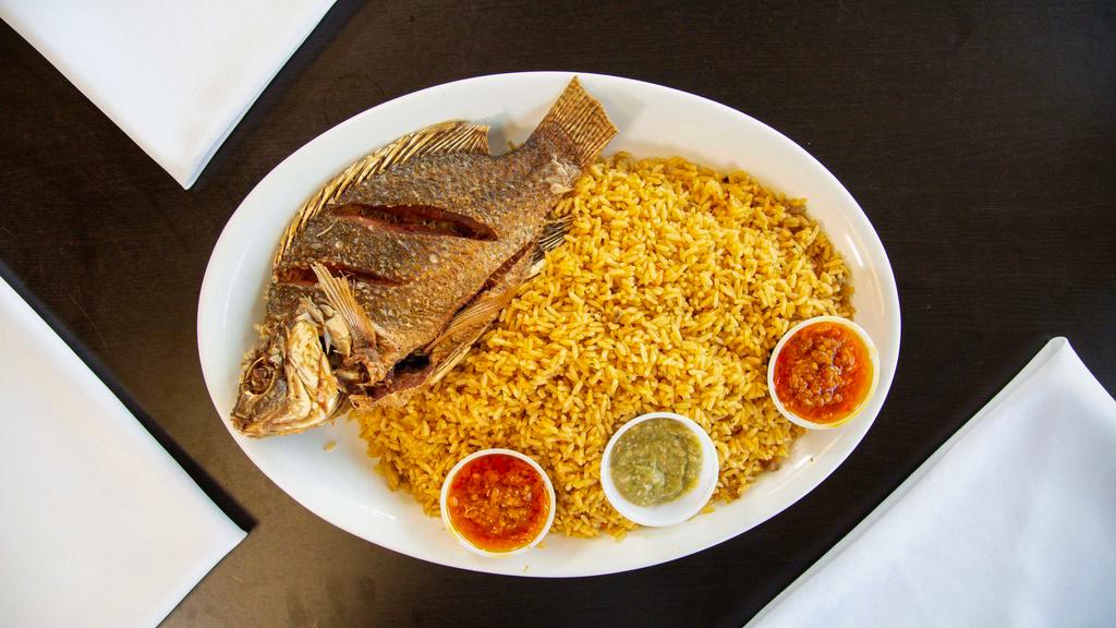 Dry Rice With Fried Tilapia Fish · Dry race season race served with Fried fish