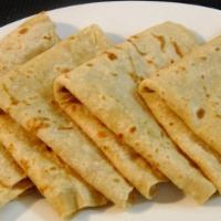 Roti Skin (Dhalpuri) · A delicate tortilla-like thin dough with pockets filled with a hearty mix of yellow split pe...