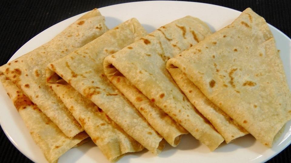 Roti Skin (Dhalpuri) · A delicate tortilla-like thin dough with pockets filled with a hearty mix of yellow split peas that have been mixed with a bold blend of spices, rolled out flat, and then cooked on a hot stone.