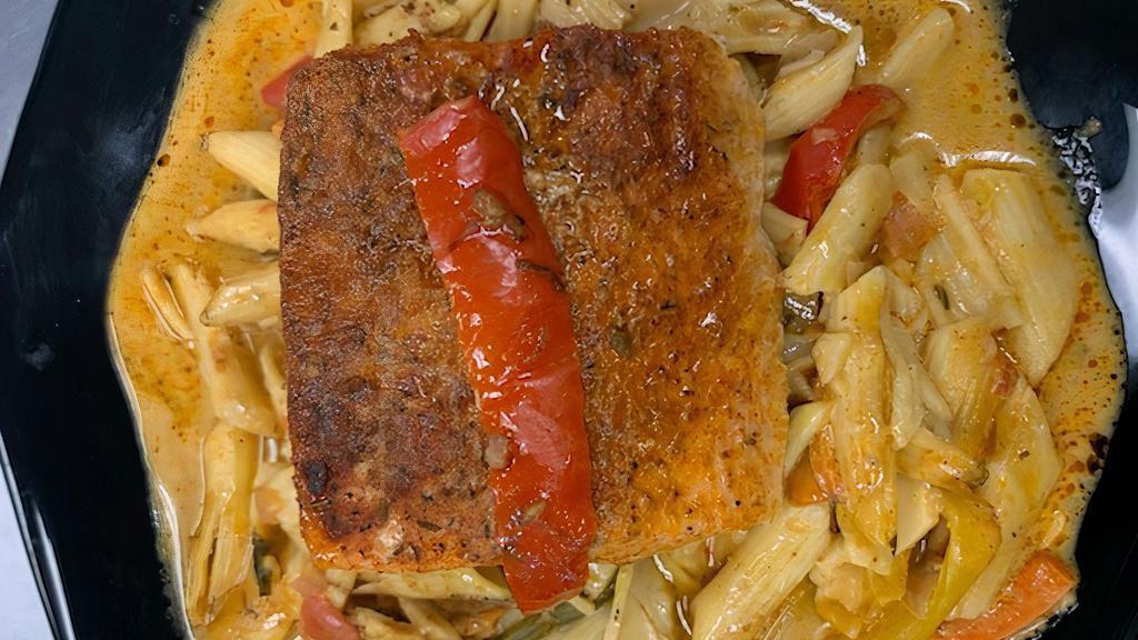 Rasta Pasta W/ Caribbean Style Salmon · Our original Caribbean style Salmon placed on a bed of creamy penne pasta seasoned with jerk spices and tossed with colorful bell peppers.