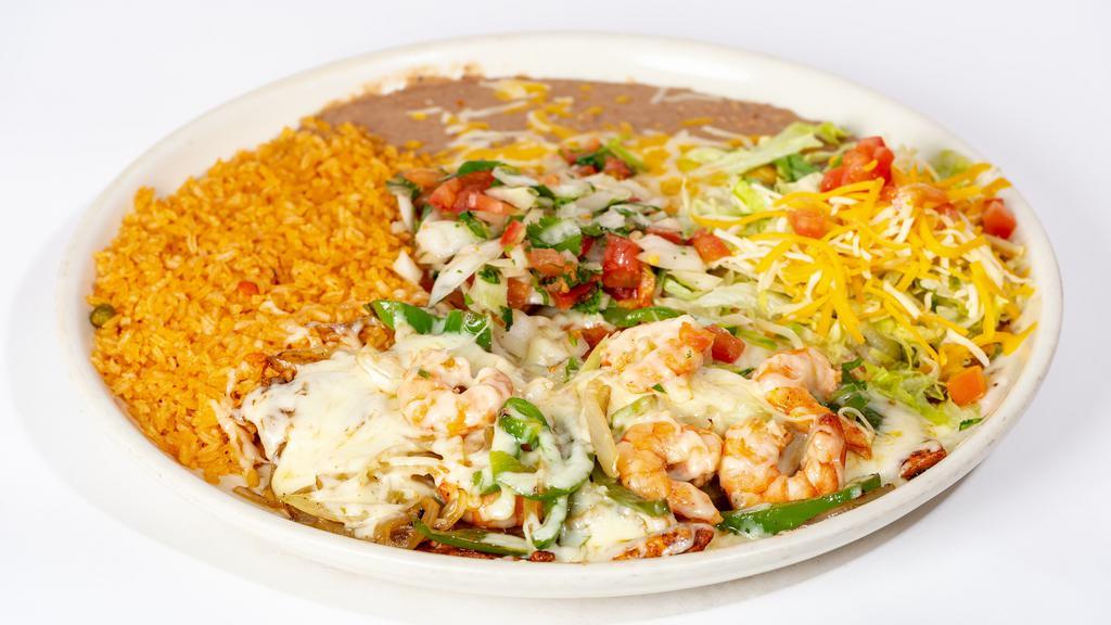 Chicken & Shrimp Monterey · Grilled chicken breast and shrimp topped with grilled onions, peppers, melted Monterey jack cheese and pico de gallo. Served. With rice, beans and tortillas garnished with lettuce, tomatoes and cheese.