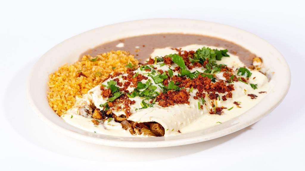 Chori Burritos · Two burritos filled with grilled chicken and onions. Smothered in our special white queso dip. Topped with cilantro and chorizo Mexican sausage. Served with rice and beans.