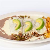 Acapulco Enchiladas · Three grilled steak or chicken enchiladas. Topped with white queso dip and sliced avocado. S...
