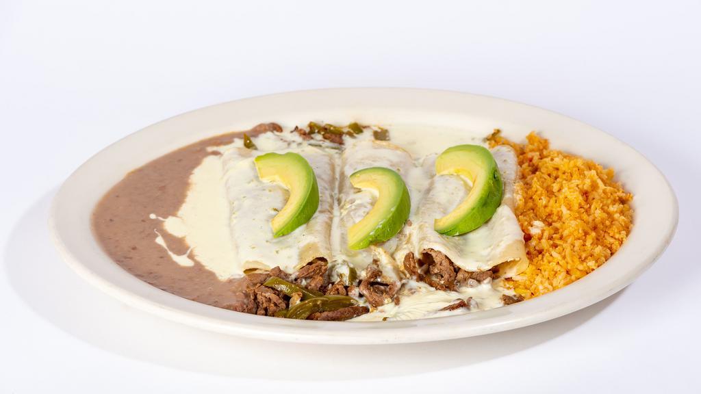 Acapulco Enchiladas · Three grilled steak or chicken enchiladas. Topped with white queso dip and sliced avocado. Served with rice and beans.