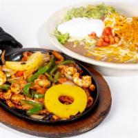 Hawaiian Fajita · Chicken, shrimp and pineapple topped with grilled onions, tomatoes and bell peppers, garnish...