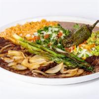 Carne Asada · Grilled skirt steak arrachera with grilled onions. Served with rice, beans, tortillas, a dee...