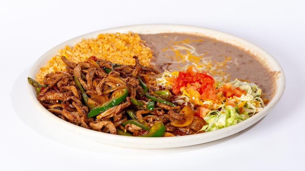 Steak Ranchero · Sirloin steak sliced and fried with bell peppers, onions, tomatoes and jalapenos. Garnished with lettuce, tomatoes and cheese. Served with rice, beans and tortillas.