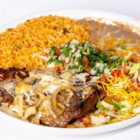 Steak Del Valle · T-bone steak grilled with onions and mushrooms. Smothered in our special white queso dip. Ga...