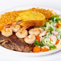 Steak De Camaron · T-bone steak with shrimp on top, served with rice, garlic bread and a mixture of steamed veg...