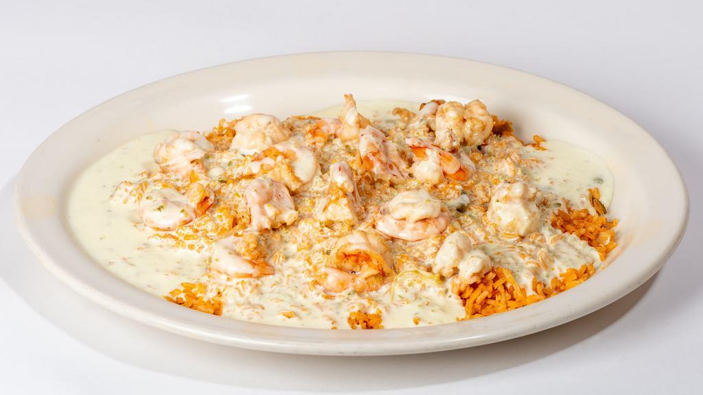 Shrimp & Rice · Sautéed shrimp over a bed of rice and topped with white queso dip.