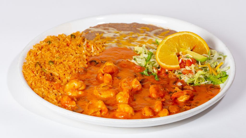 Camarones Al Mojo De Ajo · Shrimp and mushrooms sautéed in a tasty buttery garlic sauce and spices. Served with tortillas, rice, beans and a side of lettuce topped with tomatoes, cheese, sliced avocado and an orange slice.