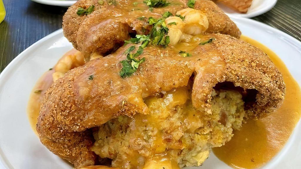 Creole Heaven · Fried Catfish over a bed of seafood cornbread dressing, smothered in Ettoufee . (can sub dressing for rice)