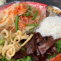 Green Papaya Salad · Gluten free. Shredded green papaya pressed with carrots in tamarind sauce and topped with pe...