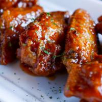 Chicken Wings · Crispy and on the bone offered simply fried or tossed in your choice of sauce. Served with c...