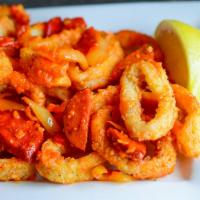 Calamari Supreme · Sauteed with garlic oil, hot peppers, black olives and fresh Parmesan cheese. Served with a ...