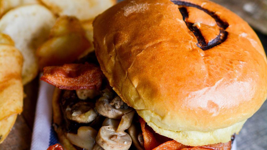 Mushroom Swiss Cheeseburger · Burger piled high with fresh sautéed mushrooms and topped with Swiss cheese, served on a grilled kaiser roll.