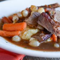 Yankee Pot Roast · Tender simmered beef served over mashed potatoes with baby carrots, pearl onions, and natura...