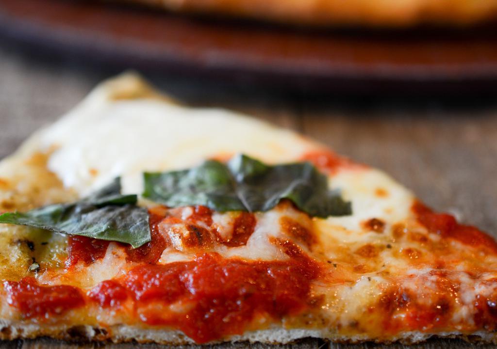 Pizza Margherita · Fresh crispy  pizza dough topped with fresh tomato sauce, mozzarella, oregano and basil