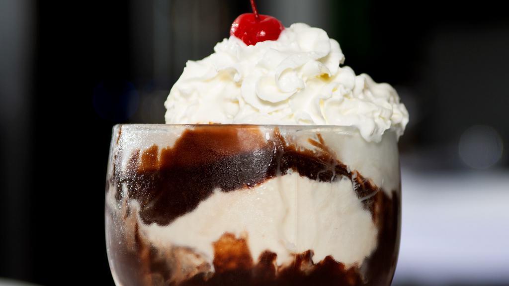 Chocolate Sundae · Two scoops of ice cream topped with hot fudge, whipped cream and a cherry on top.