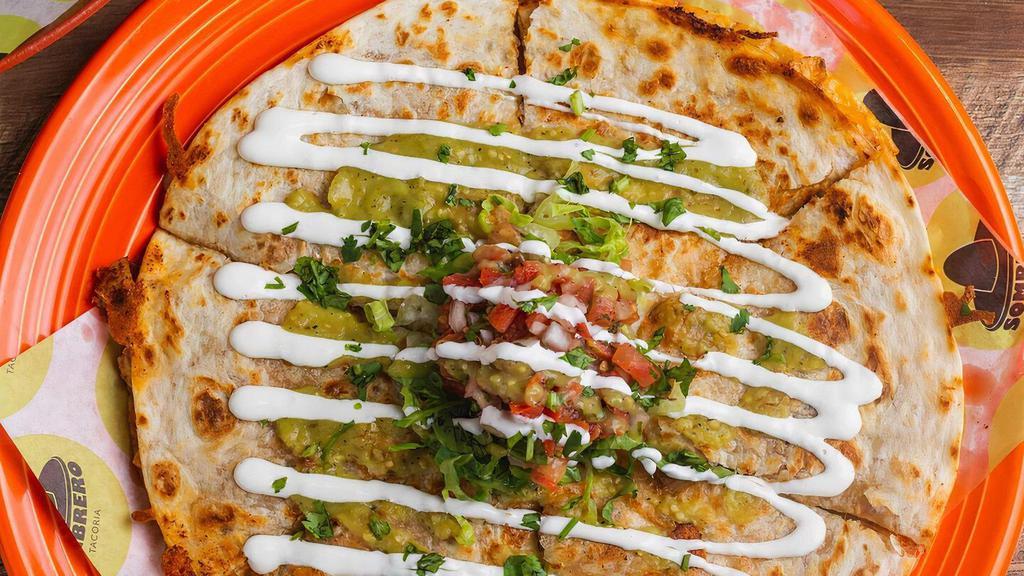 Carnitas Quesadilla · A 10” flour tortilla filled with melted mexican cheese and your choice of filling. Topped with lettuce, pico, tomatillo salsa and crema