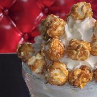 Caramel Crunch · Caramel milkshake with drizzled caramel and caramel popcorn with whipped cream and cherry.