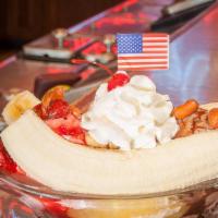 Traditional Banana Split · A scoop each of chocolate, vanilla, and strawberry ice cream topped with chocolate, pineappl...