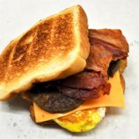 Breakfast Sandwich · With your choice of 2 Pork Sausage Patties,  2 Pork Bacon Strips or 1 Piece of Thick Ham, an...