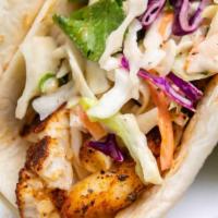 Fish Tacos · three fish tacos with rice, cabbage, onion, pineapple, chipotle dressing, cilantro.
