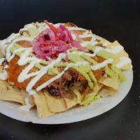 Taquiza Chips · Chips with  your choice of meat ,refried beans,  cheese, sour cream, guacamole, and cotija c...