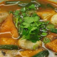 Tom Kha (Bowl) · Chicken soup with coconut milk, mushroom, tomato, scallions, cilantro and Thai herbs.
