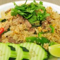 Thai Fried Rice · Fried rice with golden brown sauce, egg, tomato, onion, scallions and cilantro. Can be made ...