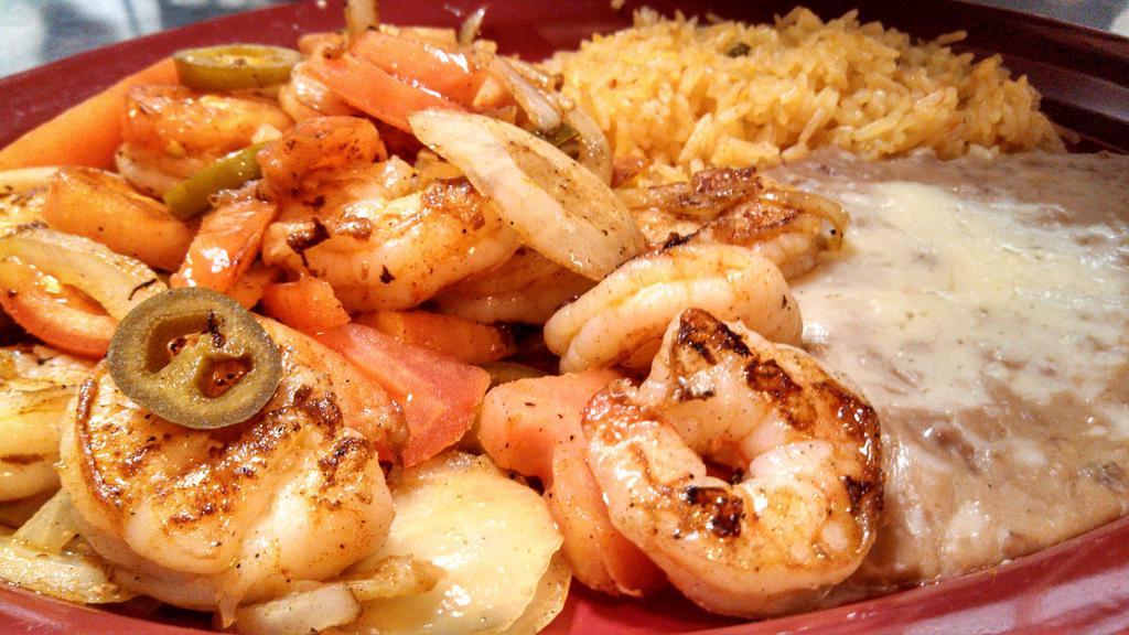 Camarones Tapatios · Jumbo shrimp grilled with jalapenos, onions, and tomatoes. Served with rice, beans, and flour tortillas.