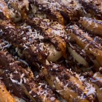 Dirty Banana  · banana, peanut butter, melted semisweet chocolate, dark chocolate, coconut flakes on your ch...