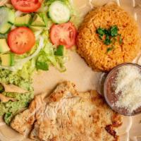 Pechuga De Pollo · Marinated chicken breast served with rice, beans, and a house salad.
