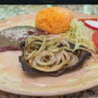 Bistec Encebollado · Grilled steak served with rice, beans, and a house salad.