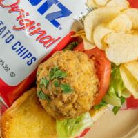 Crab Cake Sandwich · Our award-winning broiled crab cake on a toasted bun with lettuce, tomato, remoulade, and a ...