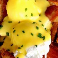 Eggs In Jail · Two poached eggs incarcerated in a circle of bacon and toast with hollandaise.  Served with ...