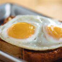 Always Sunny · Grilled sausage, provolone, cheddar, and Swiss topped with sunny-side-up eggs over fresh-bak...