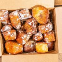 French Toast Bites · Cinnamon sugar bites, tossed in maple syrup and topped with powdered sugar.