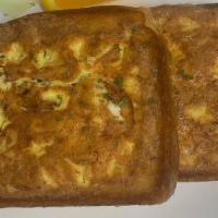 Stuffed Omelet Toast · Two Texas Toast stuffed with scrambled eggs, American cheese and your choice of bacon or sau...