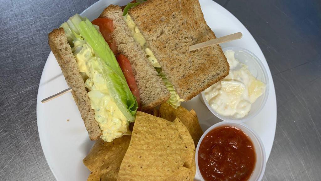 Egg Salad Sandwich · Our egg salad is made with mayonnaise, salt, pepper and a hint of deli mustard. The sandwich comes on your choice of toast, tomatoes and leafy greens.
