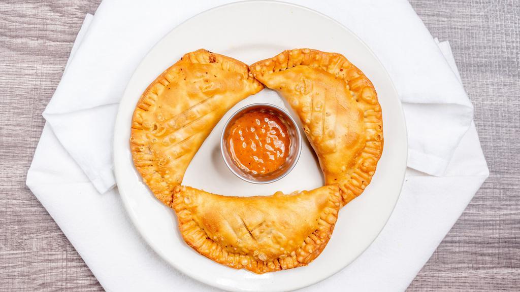 Empanadas · 3 fried pastries stuffed with seasoned ground beef and cheese. Served with rojo salsa.