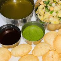 Pani Puri · Tiny Little Wheat Shells Served with Potatoes, Chick Peas and Spiced Water.