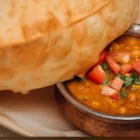 Channa Batura · Extra Large Deep Fried Puffy Bread Served with Chick Peas Curry.
