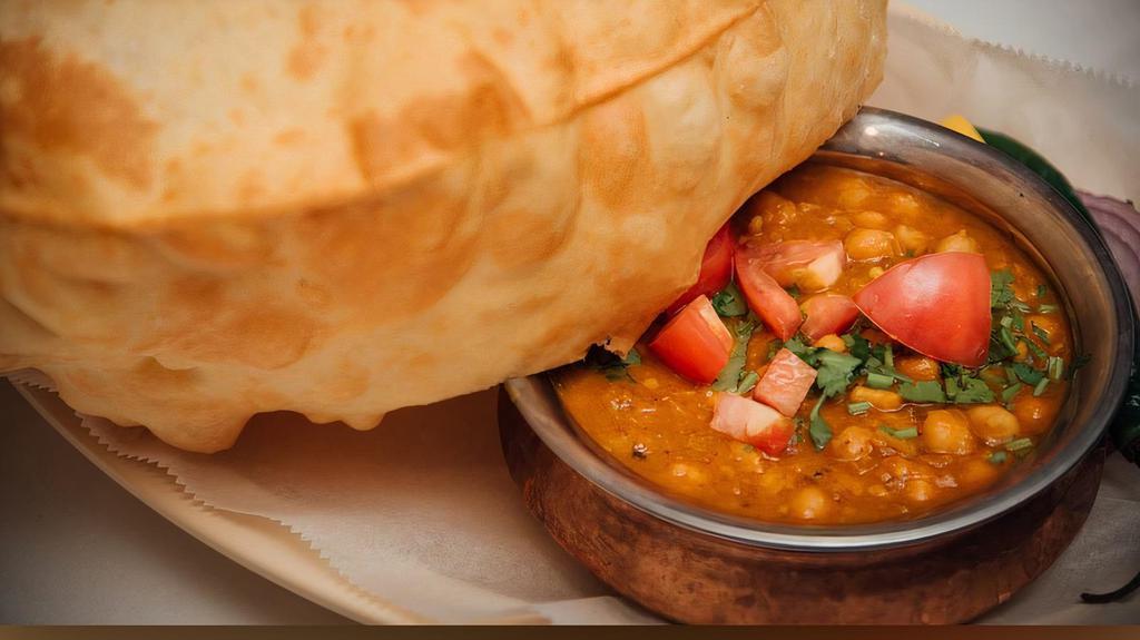 Channa Batura · Extra Large Deep Fried Puffy Bread Served with Chick Peas Curry.