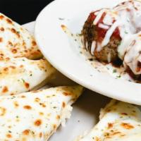 Meatballs & Cheese Bread · 4 of our amazing meatballs covered with sauce and baked mozzarella served with a 1/2 order o...