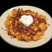 Loaded Fries · Top our traditional waffle fries with cheddar cheese, loads of bacon, sour cream and jalapen...