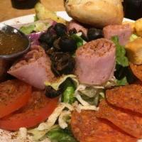 Antipasto Salad · An Italian Chef salad featuring pepperoni, ham, salami, mozzarella, roma tomatoes, black oli...