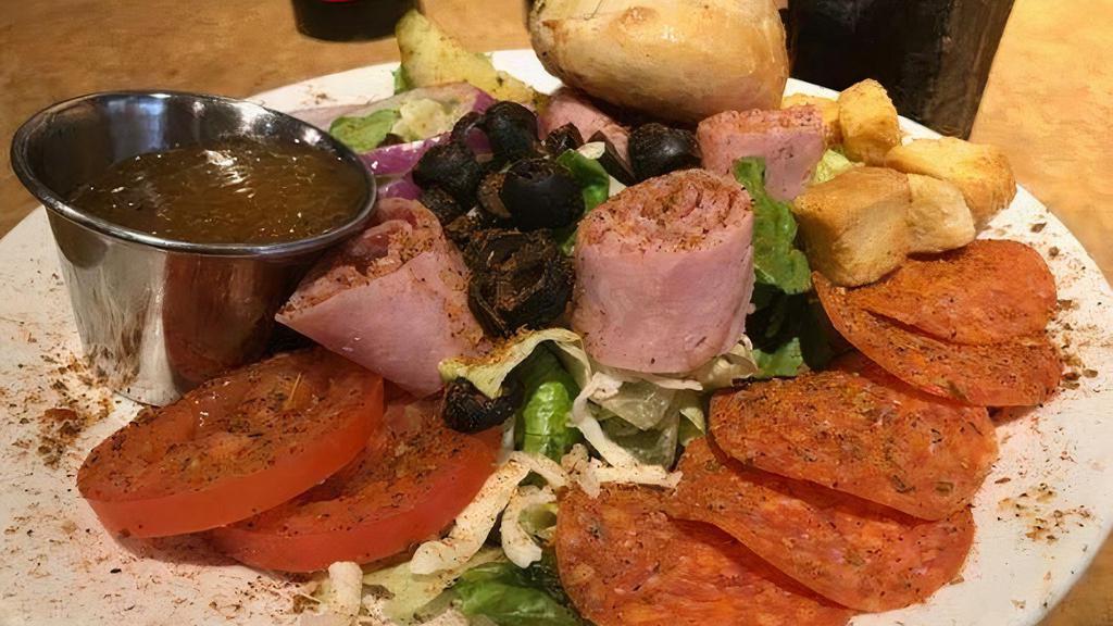 Antipasto Salad · An Italian Chef salad featuring pepperoni, ham, salami, mozzarella, roma tomatoes, black olives, onions, and a pickle atop a bed of fresh ice berg and romaine lettuce.
