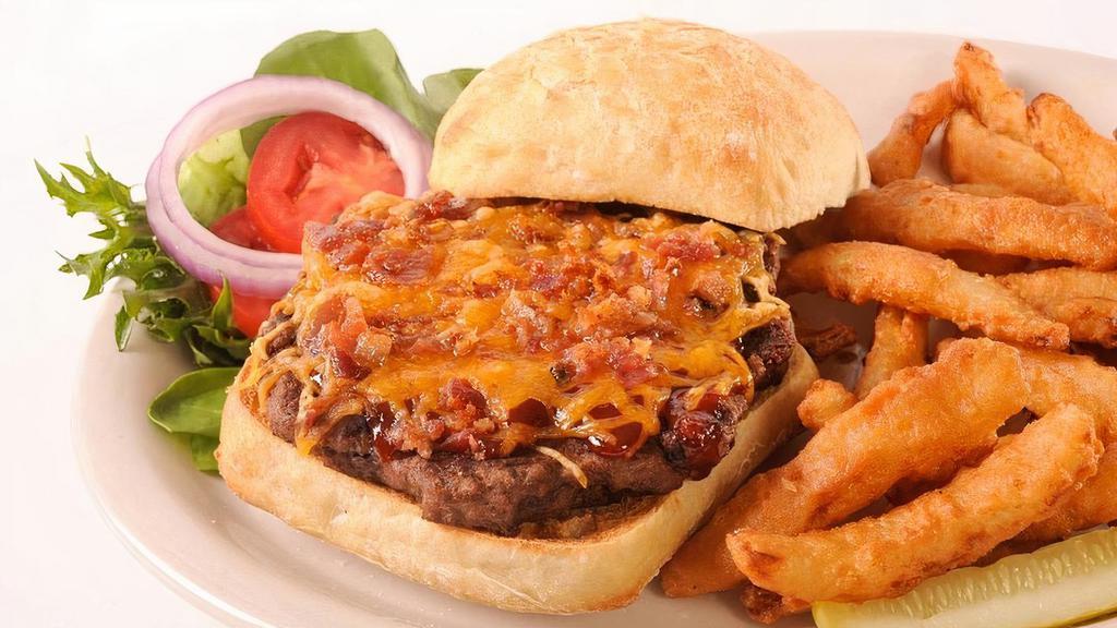 Cowboy Burger · 1/3 pound black Angus burger seasoned with our signature spice, cooked to medium well and garnished with lettuce, tomato, onion, a pickle spear, and smothered with BBQ sauce, bacon and cheddar.